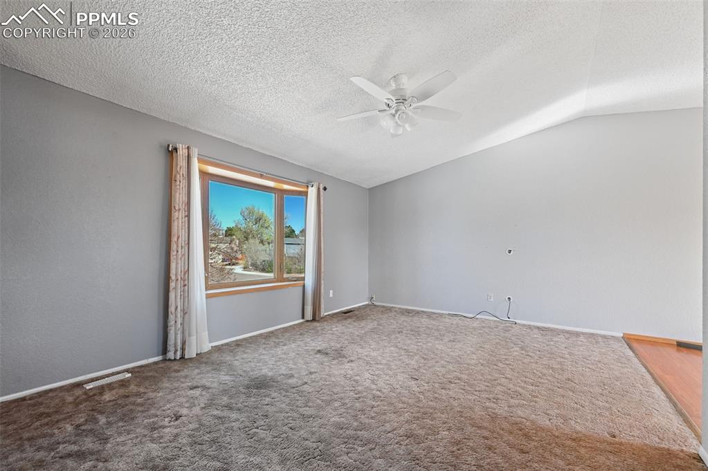 4963 Ridenour Drive Colorado Springs, CO 80916 - Photo 3 of 25 Carpeted spare room with a ceiling fan and baseboards