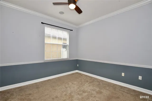 an empty room with closet and windows