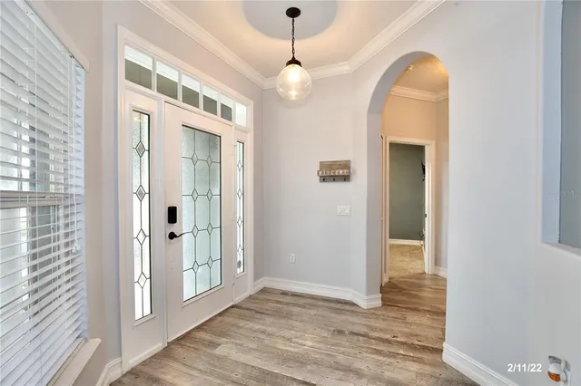 a view of a room with wooden floor and windows