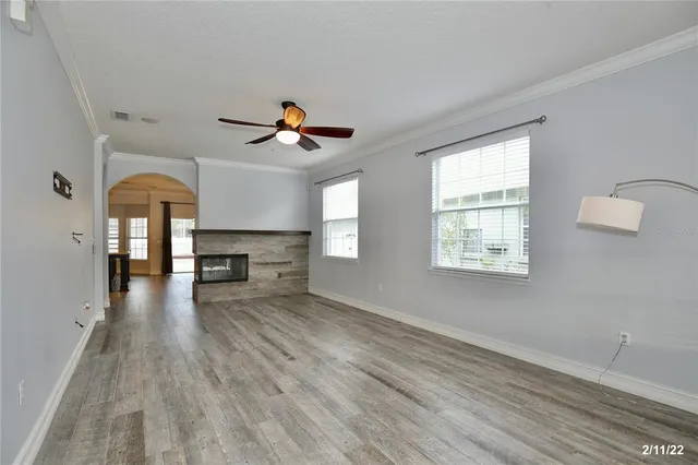 wooden floor in an empty room with a window