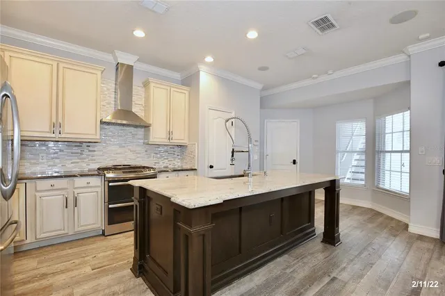 a kitchen with a sink stove and cabinets
