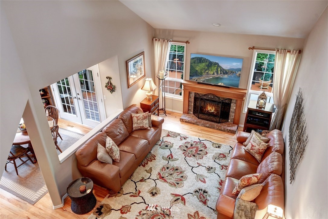 15420 Southeast 133rd Street Renton, WA 98059 - Photo 13 of 26 a living room with furniture a fireplace and a floor to ceiling window