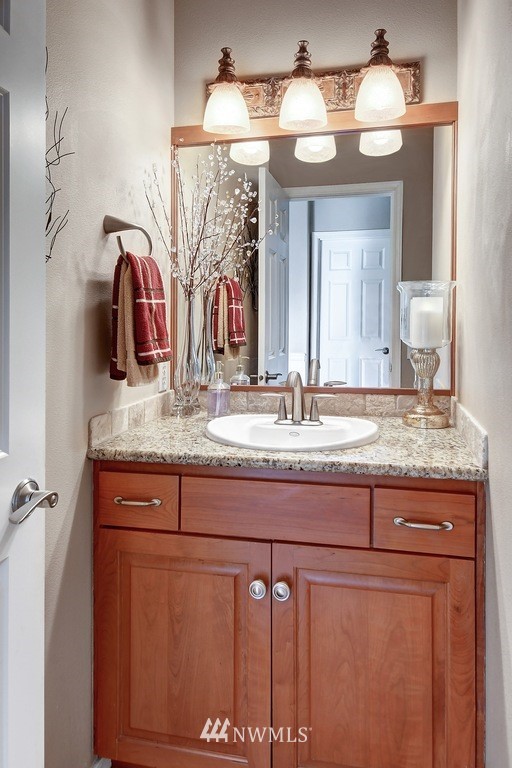 15420 Southeast 133rd Street Renton, WA 98059 - Photo 14 of 26 a bathroom with a granite countertop sink and a mirror