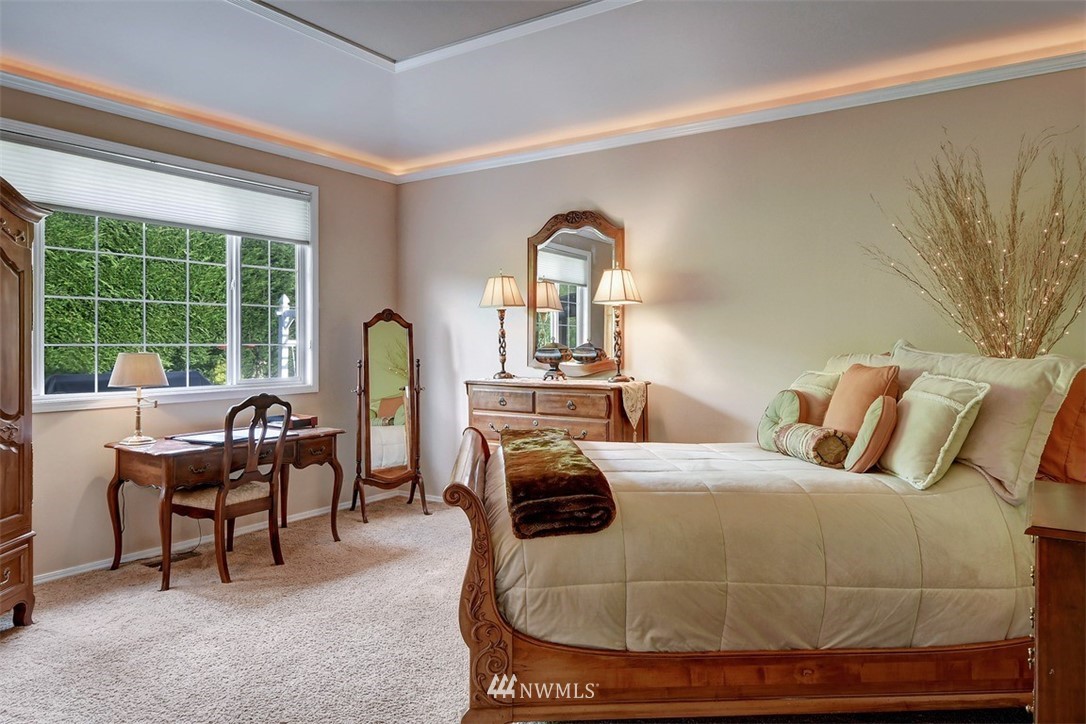 15420 Southeast 133rd Street Renton, WA 98059 - Photo 15 of 26 a bedroom with a bed and a large window