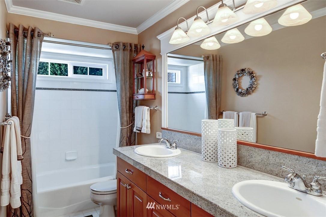15420 Southeast 133rd Street Renton, WA 98059 - Photo 21 of 26 a bathroom with a granite countertop sink a toilet and shower