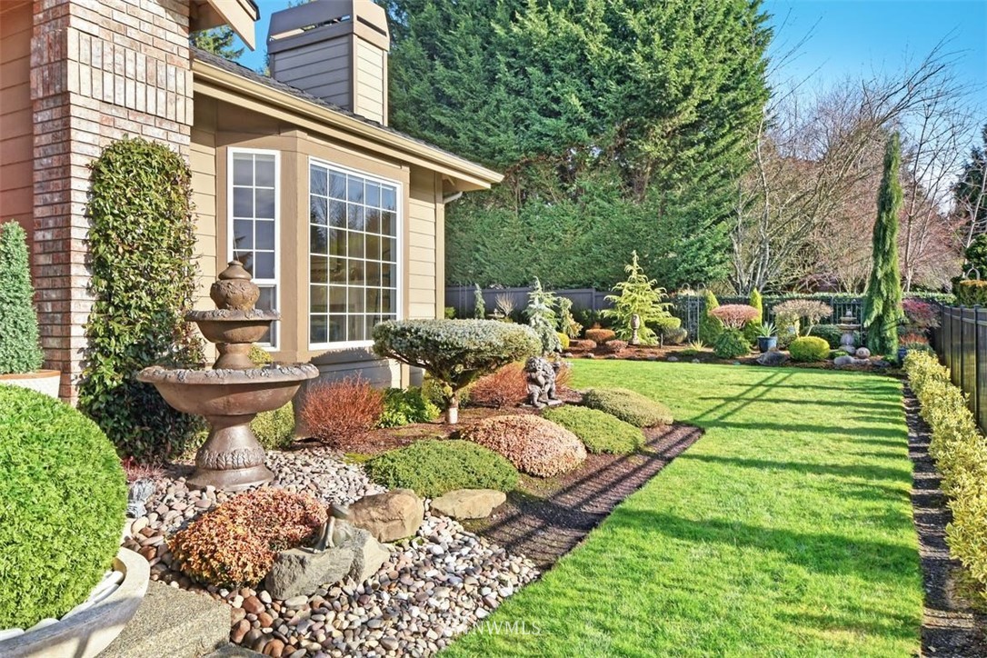 15420 Southeast 133rd Street Renton, WA 98059 - Photo 23 of 26 a front view of a house with a yard table and chairs