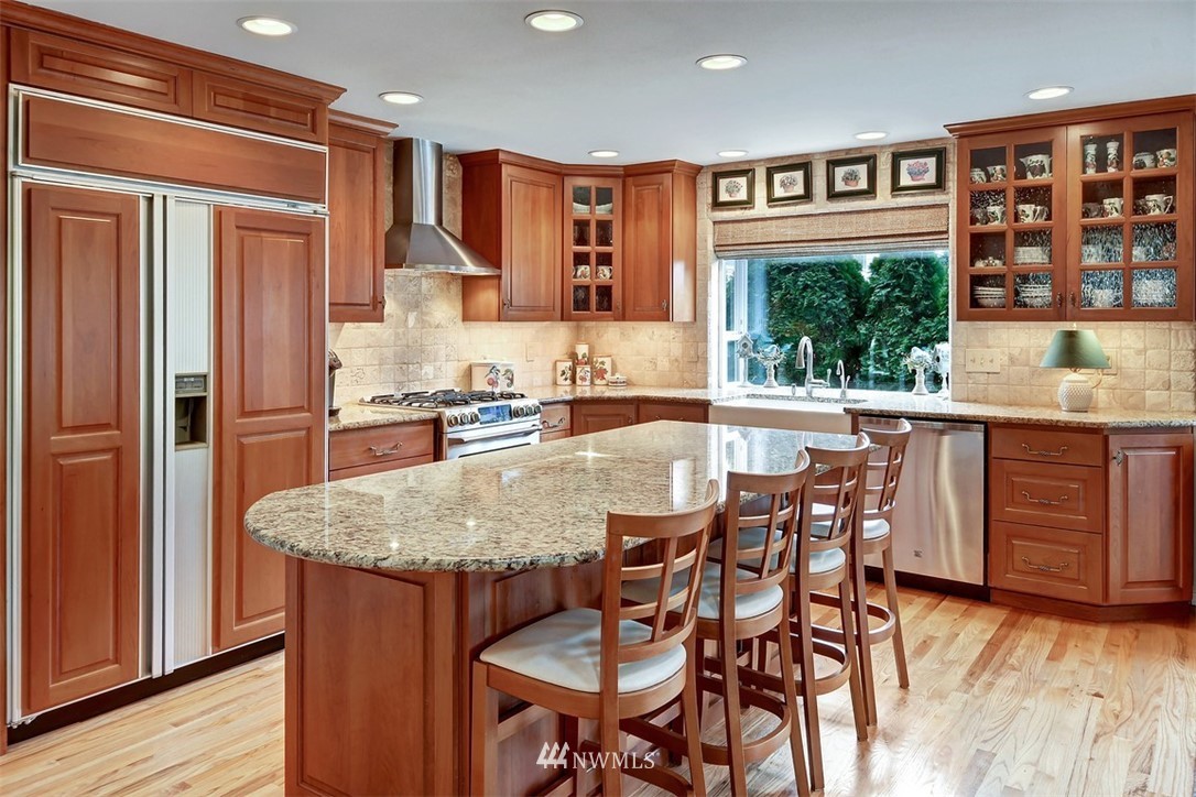 15420 Southeast 133rd Street Renton, WA 98059 - Photo 7 of 26 a kitchen with granite countertop a table and chairs in it