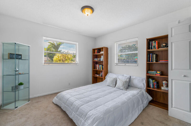 22775 Neptune Road Boca Raton, FL 33428 - Photo 11 of 18 a bedroom with a bed and a book shelf
