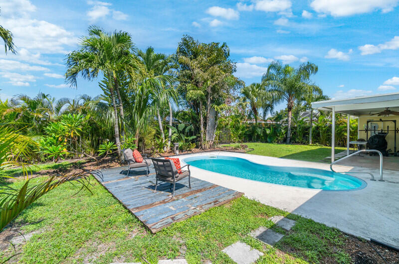 22775 Neptune Road Boca Raton, FL 33428 - Photo 15 of 18 a view of a backyard with swimming pool