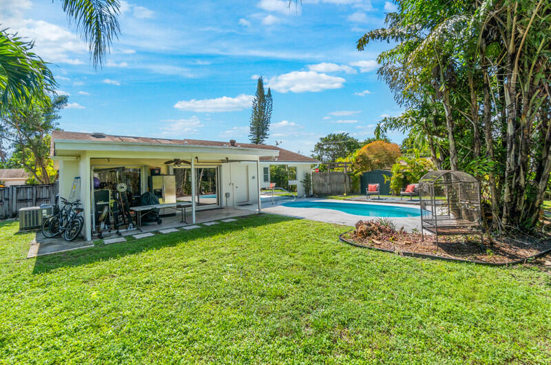 22775 Neptune Road Boca Raton, FL 33428 - Photo 17 of 18 a view of a house with a backyard porch and sitting area