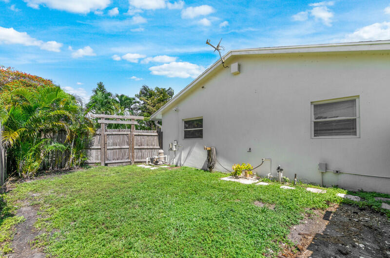 22775 Neptune Road Boca Raton, FL 33428 - Photo 18 of 18 a backyard of a house with table and chairs
