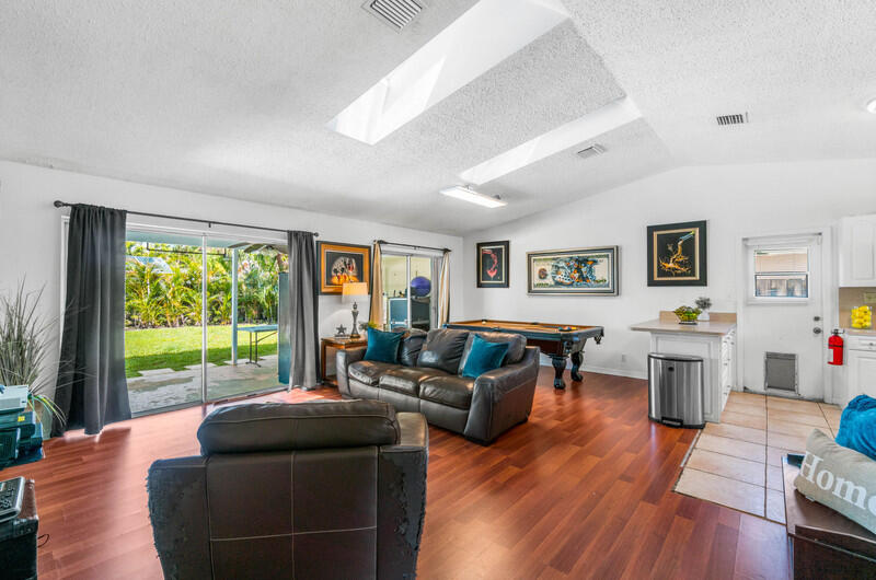 22775 Neptune Road Boca Raton, FL 33428 - Photo 6 of 18 a living room with furniture and a large window