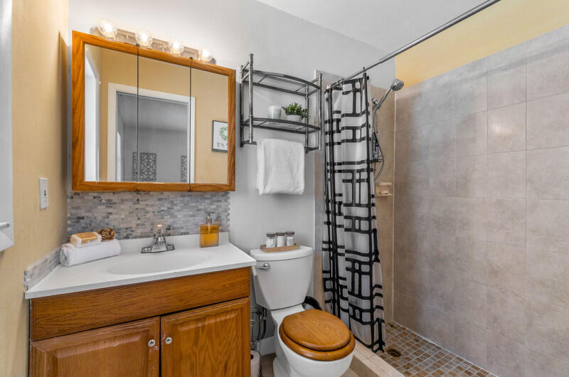22775 Neptune Road Boca Raton, FL 33428 - Photo 10 of 18 a bathroom with a sink toilet and shower