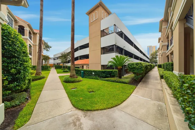 a view of a multi story building with yard