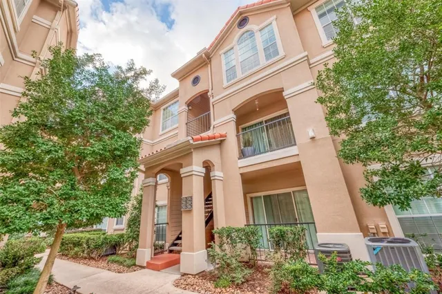 a white bench sitting in front of a building