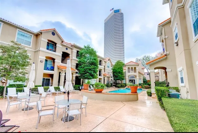 a view of a brick building next to a yard
