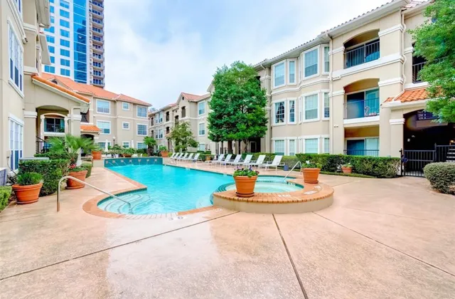 a swimming pool with outdoor seating and plants