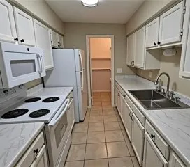 a kitchen with a sink stove and refrigerator