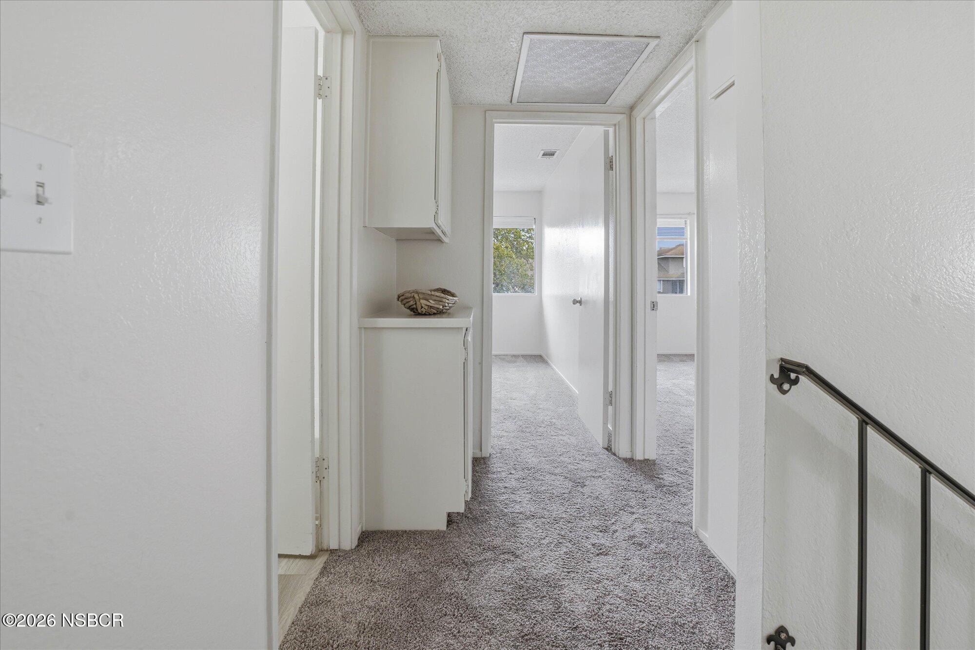 1192 Sumner Place, Unit D Santa Maria, CA 93455 - Photo 12 of 18 a view of a hallway with two rooms