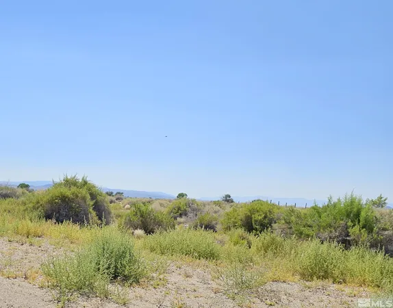 a view of a lake and green valley