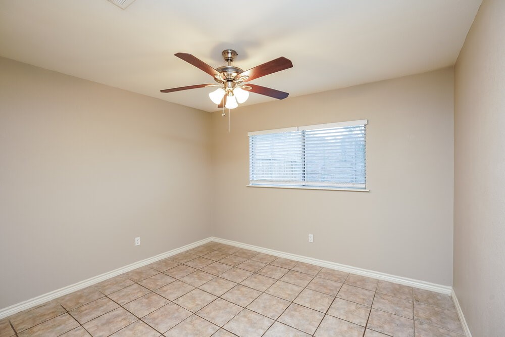 20117 Dawn Mist Drive Humble, TX 77346 - Photo 14 of 16 an empty room with a window and a fan