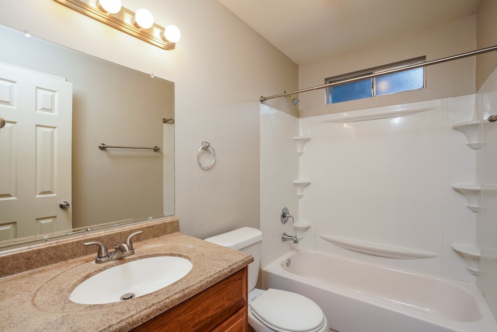20117 Dawn Mist Drive Humble, TX 77346 - Photo 15 of 16 a bathroom with a granite countertop sink toilet and shower