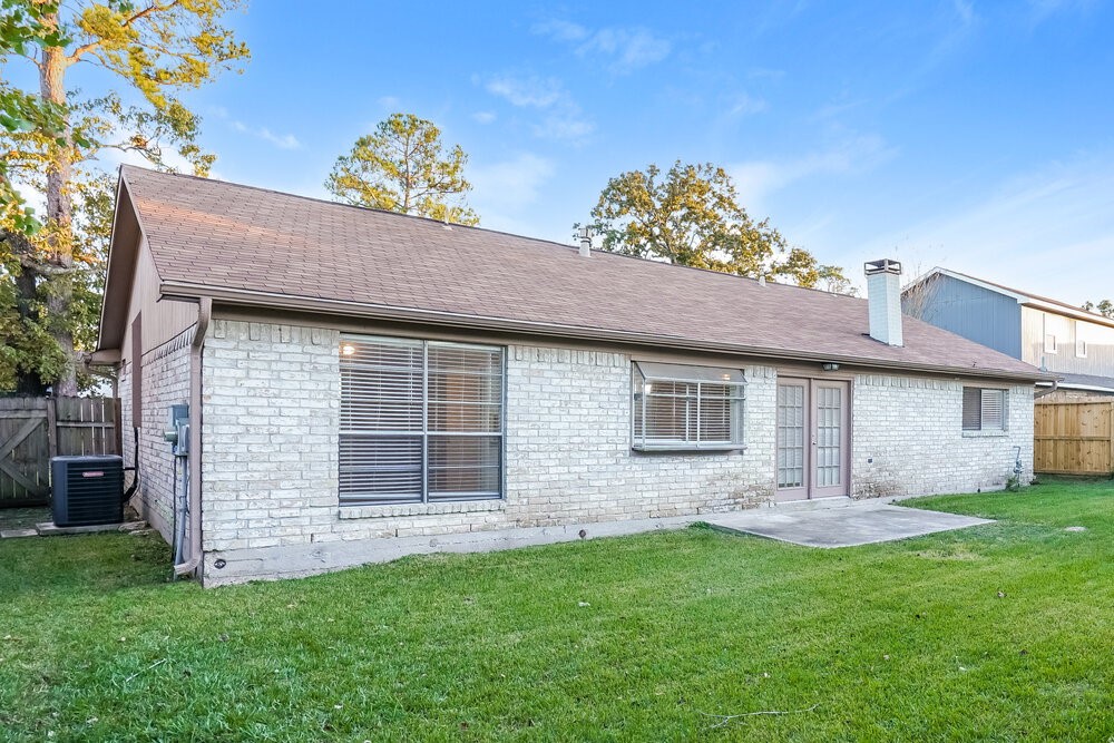 20117 Dawn Mist Drive Humble, TX 77346 - Photo 16 of 16 a front view of house with yard and trees in the background