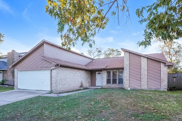 an empty room with fan and fireplace