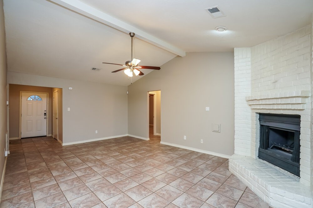 20117 Dawn Mist Drive Humble, TX 77346 - Photo 4 of 16 an empty room with fan and fireplace