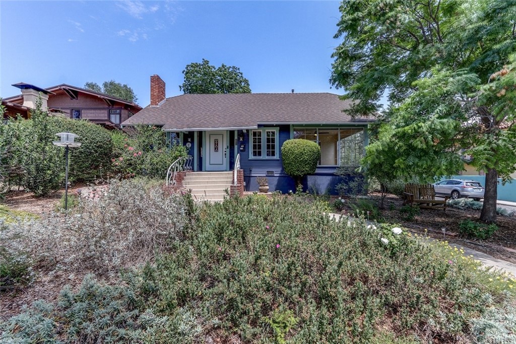 a front view of house with yard and trees