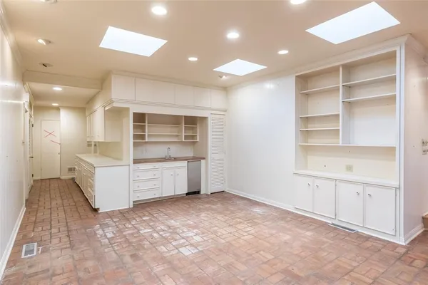 a large room with a lot of counter space and windows