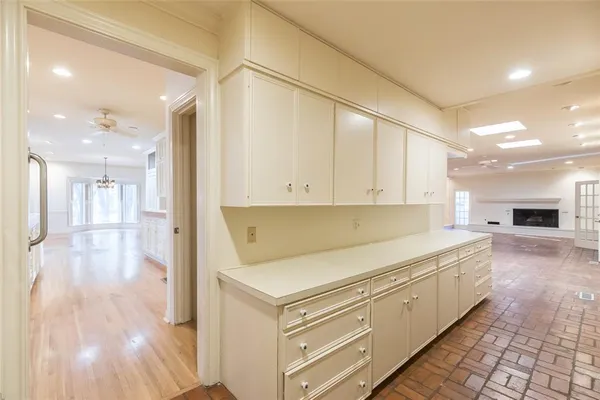 a kitchen with granite countertop white cabinets and white appliances