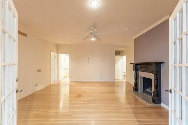 a view of an empty room with a fireplace and a window