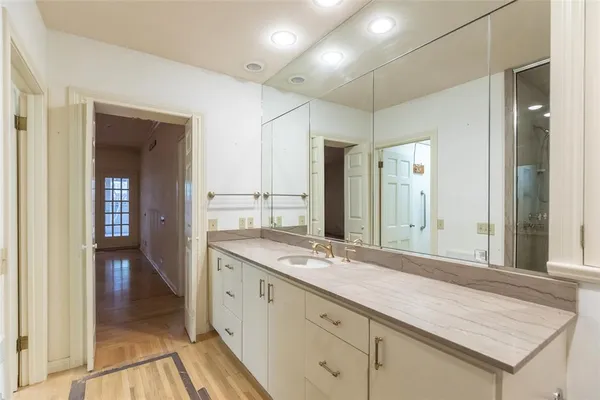 a bathroom with a granite countertop sink mirror and double