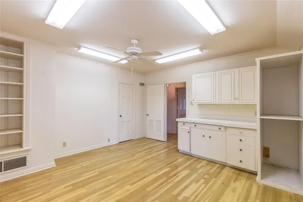a view of a kitchen with marble countertop cabinets and wooden floor