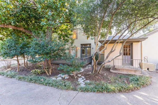 front view of a house with a tree
