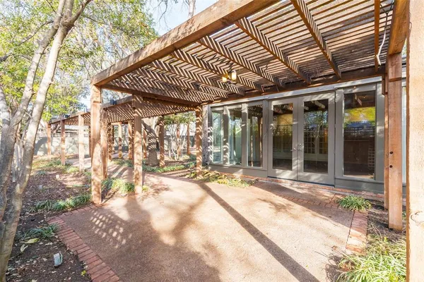 a view of a patio with a table and chairs and floor to ceiling window
