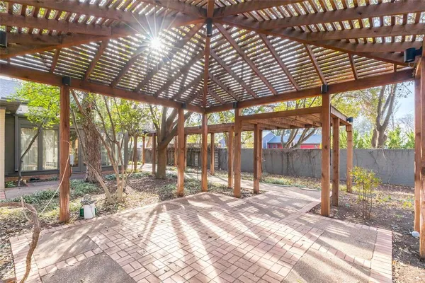 a view of a patio with a table chairs and wooden fence