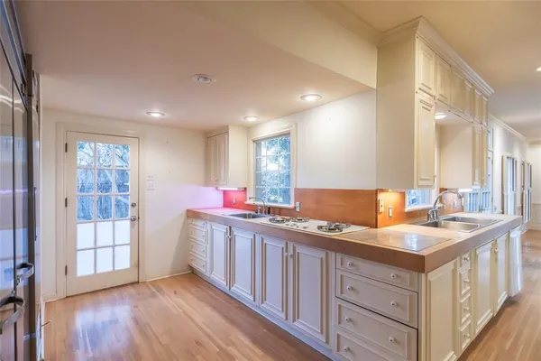 a kitchen with a sink stove and cabinets