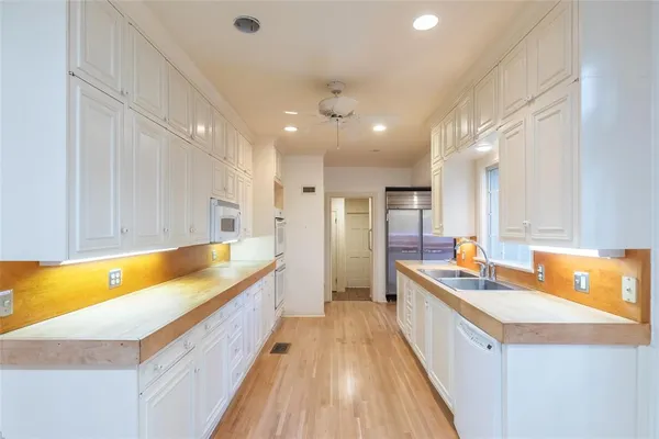 a spacious bathroom with a granite countertop sink mirror and a bathtub