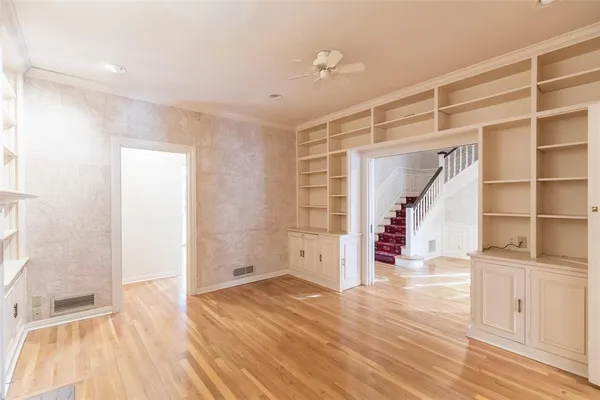 a view of empty room with wooden floor and entryway