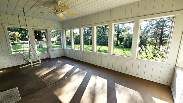 a large kitchen with cabinets wooden floor and a chandelier