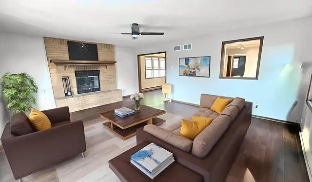 a view of a kitchen with wooden floor and a window