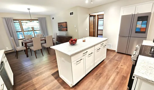 a bathroom with a sink vanity granite and a mirror