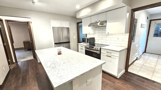 a bathroom with a sink a toilet a mirror and shower