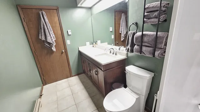 a spacious bathroom with a granite countertop sink and a bathtub