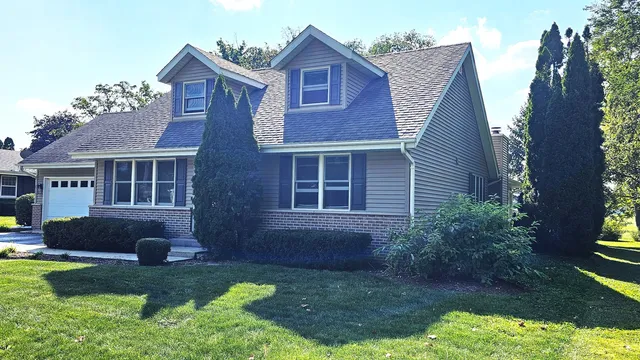 a view of a house with a yard and sitting area