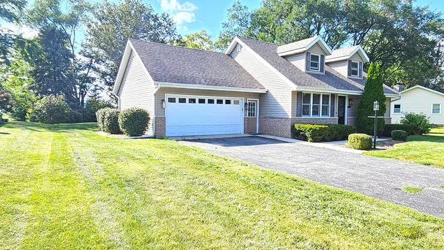a front view of house with yard barbeque and outdoor seating
