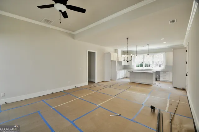 a view of kitchen with refrigerator and window