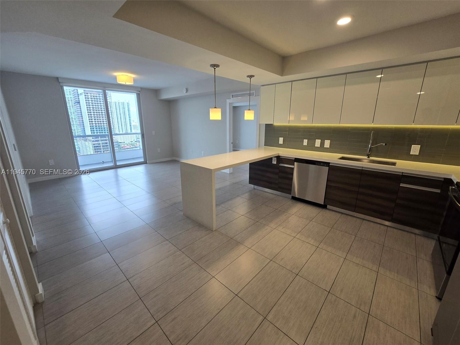 117 Southwest 10th Street, Unit 2206 Miami, FL 33130 - Photo 11 of 22 a large kitchen with a sink and cabinets